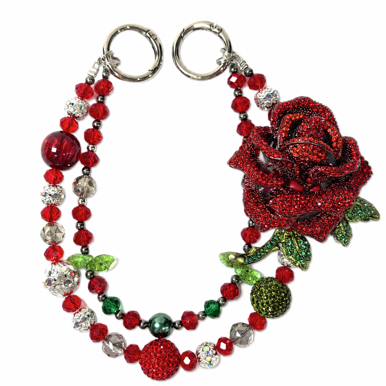 Red beaded bag charm with a large rose centerpiece and green leaf accents.