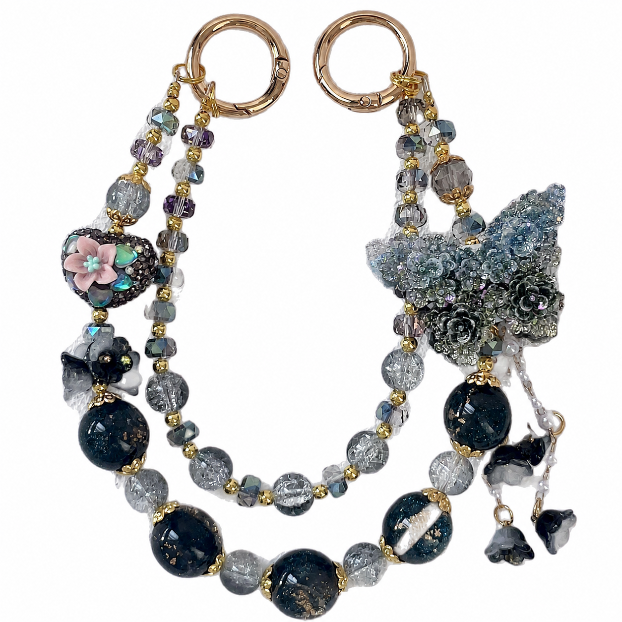 Midnight garden-style beaded bag charm with dark floral and butterfly-inspired decorative elements.