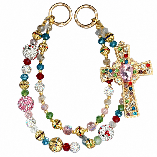 Multicolor beaded bag charm with a cross centerpiece and bright decorative accents.
