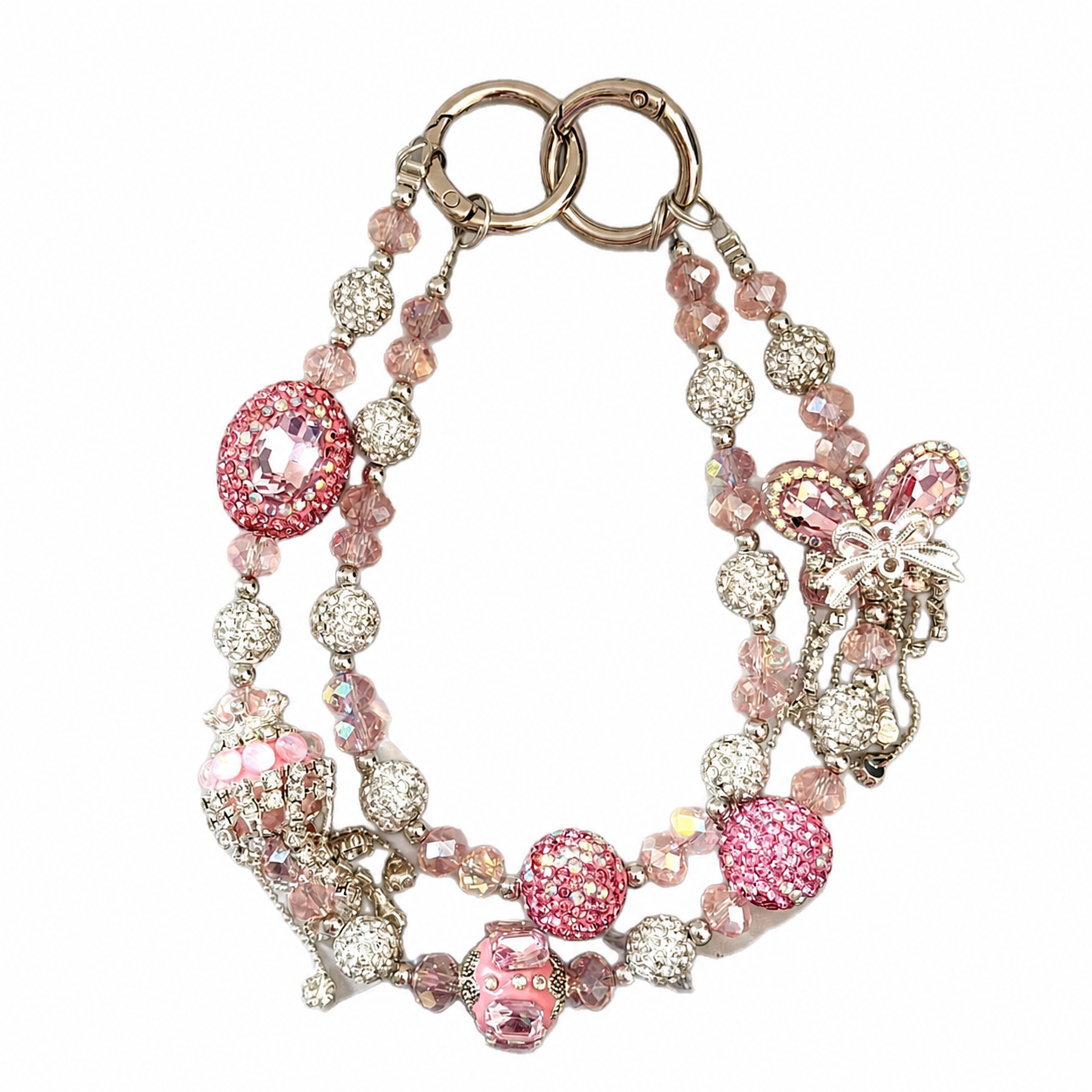 Blush-pink beaded bag charm with a bow centerpiece and decorative hanging details.