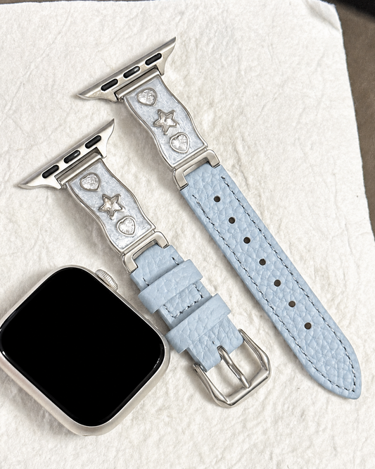 Light blue leather-look watch band with heart and star accent links and a buckle closure.