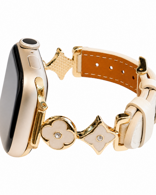 Ivory leather-look watch band with gold-tone flower and star decorative links.