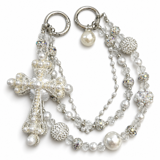 White and clear beaded bag charm with a large pearl-inspired cross centerpiece.